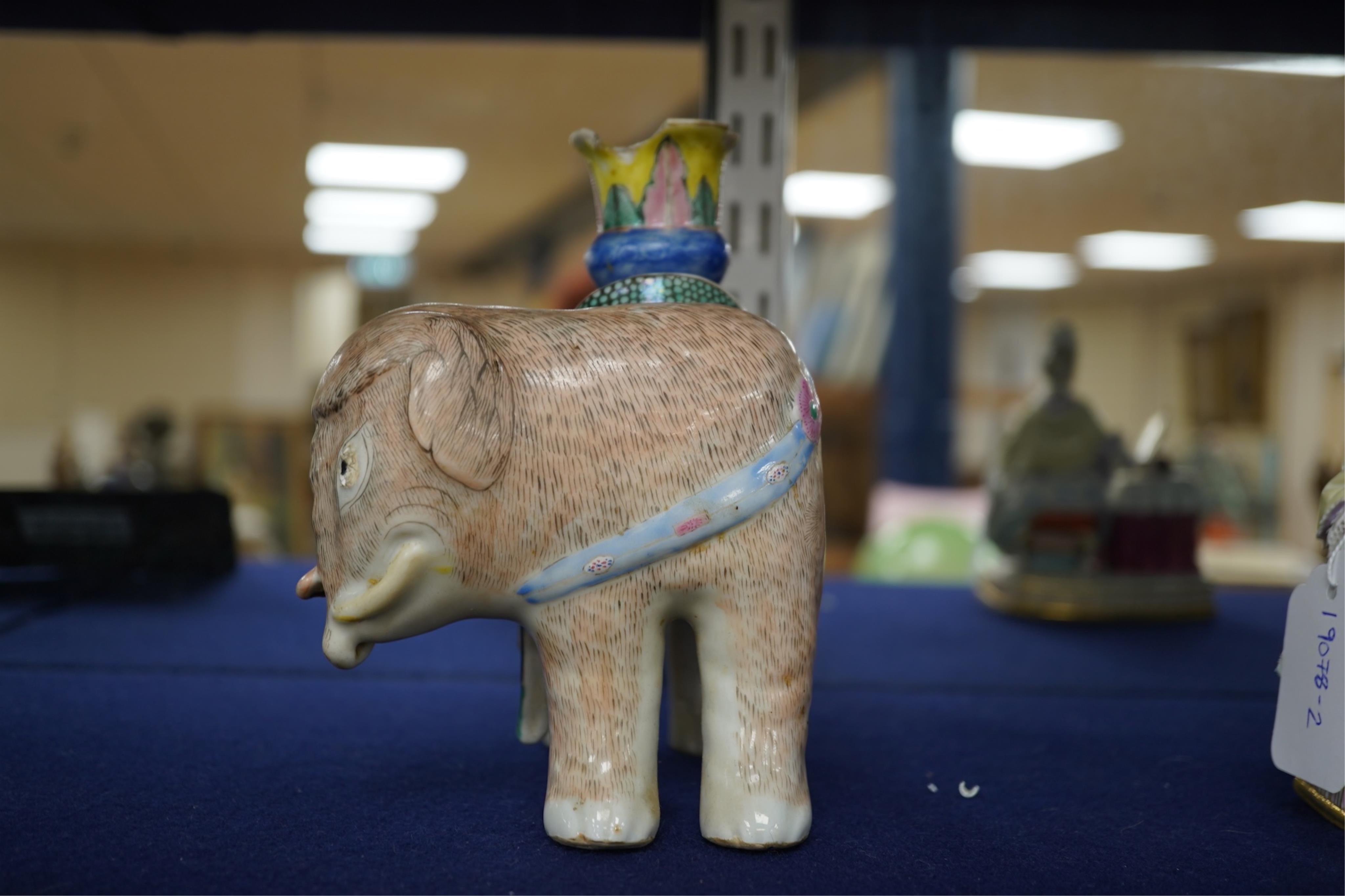 A 19th century Chinese enamelled porcelain vase in the form of an elephant with a howdah on its back